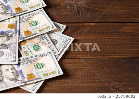 new 100 US dollars bills on wooden background new 100 US dollars bills on wooden background 20709082