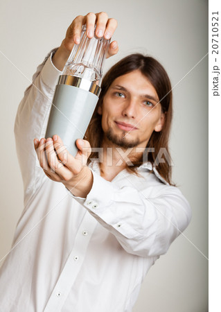 Young man with shaker making cocktail drink 20710521