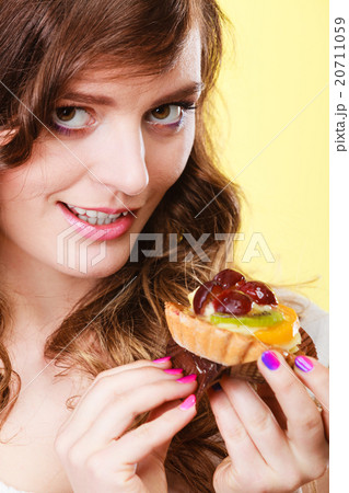 Smiling cute woman holds fruit cake in hand Smiling cute woman holds fruit cake in hand 20711059