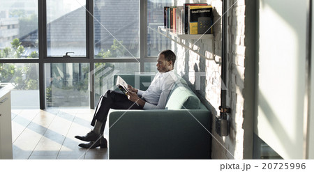 Businessman Reading Magazine Relaxation Concept 20725996