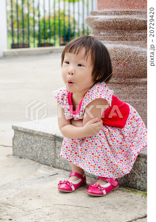 Asian girl with surprised face sitting on the floor 20729420