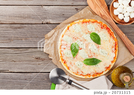 Quattro fromaggi pizza with basil 20731315