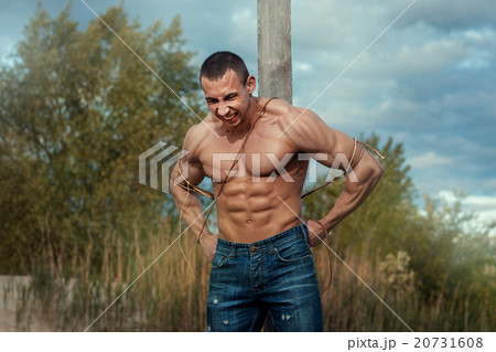 Man tied to a pillar. Man tied to a pillar. 20731608