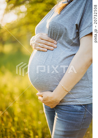 Pregnant woman at sunset 20732508