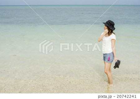 沖縄県恩納村の海辺に横向きで立つ女性 沖縄県恩納村の海辺に横向きで立つ女性 20742241