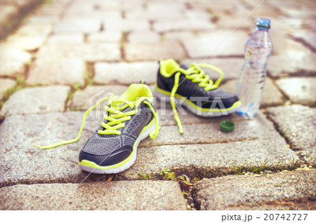 Running shoes and bottle of water 20742727