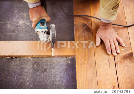 Carpenter grinding wooden planks Carpenter grinding wooden planks 20742793