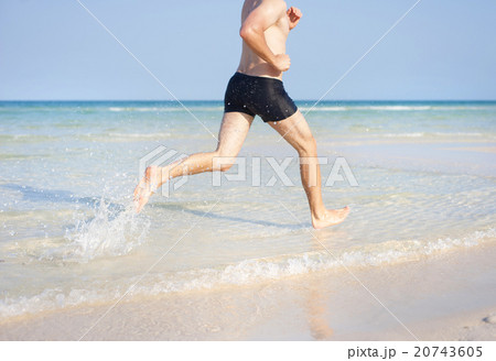 Man running on the beach Man running on the beach 20743605