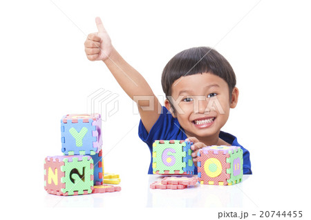 Cute boy playing with letters and showing thumb up Cute boy playing with letters and showing thumb up 20744455