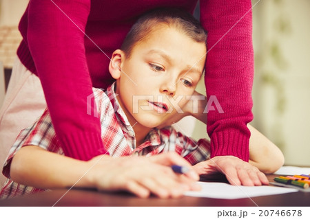 Boy is doing homework Boy is doing homework 20746678