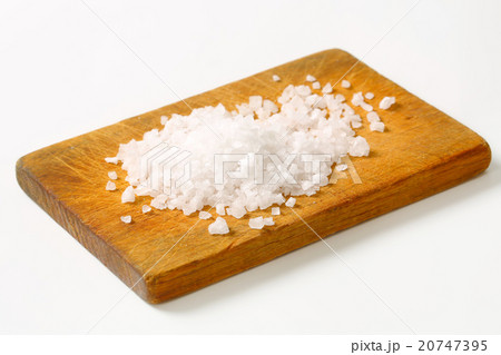 Coarse sea salt on cutting board Coarse sea salt on cutting board 20747395