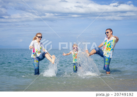 Happy family playing on the beach at the day time. Happy family playing on the beach at the day time. 20749192