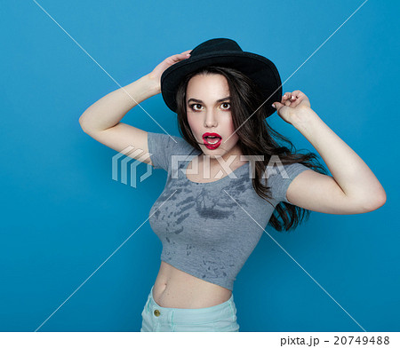 Girl in hat and in a wet t-shirt - Stock Photo [20749488] - PIXTA