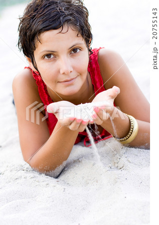 woman in red lying on a sand 20755143