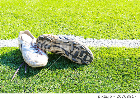 Old football shoes on green grass 20763817