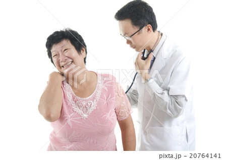 Image of a doctor and his nurse checking up a senior patient in Image of a doctor and his nurse checking up a senior patient in 20764141