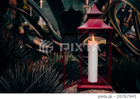 One burning candle on a nature background. 20767945