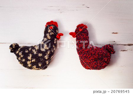 Two colorful knitted Easter hens, white wooden Two colorful knitted Easter hens, white wooden 20769545