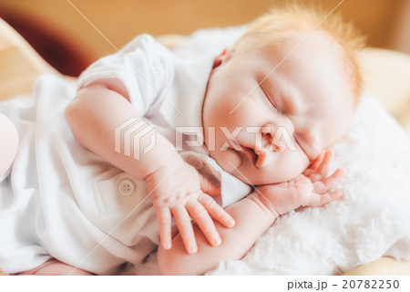 Newborn baby boy with pajamas sleeping in basket Newborn baby boy with pajamas sleeping in basket 20782250