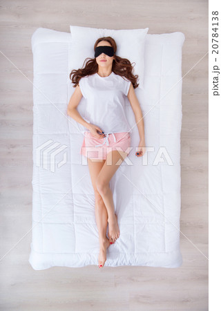 Charming woman lying in bed  20784138