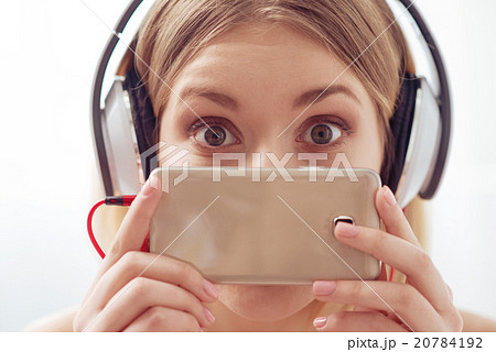 Using smartphones and earphones is popular Using smartphones and earphones is popular 20784192