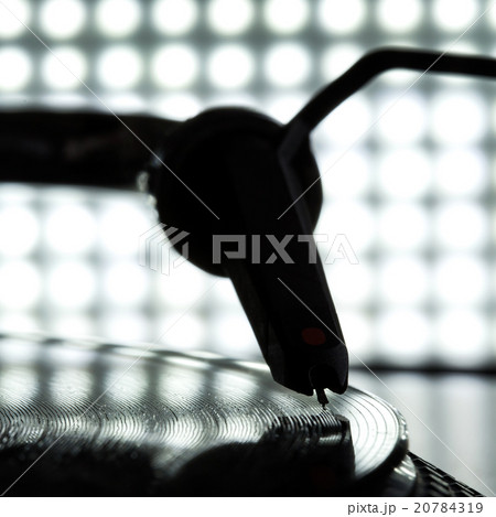 Dj needle stylus on record, blur light background 20784319