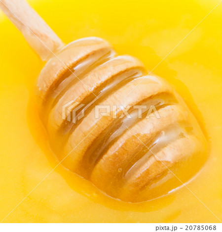 wooden spoon in yellow honey close up wooden spoon in yellow honey close up 20785068