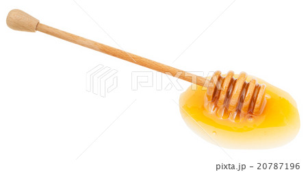 puddle of transparent honey and wooden stick puddle of transparent honey and wooden stick 20787196
