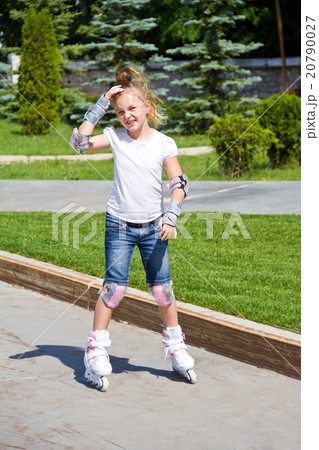 Learning girl on roller skates Learning girl on roller skates 20790027