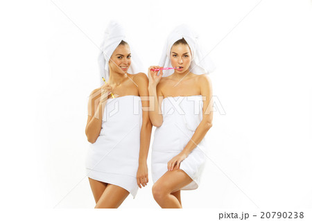 Two girls brush their teeth after shower Two girls brush their teeth after shower 20790238