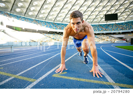 Young sportsman is at large modern stadium 20794280