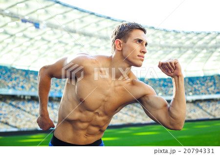 Young sportsman is at large modern stadium 20794331