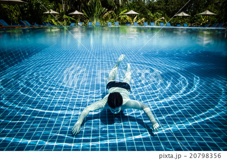Man floats underwater in pool Man floats underwater in pool 20798356