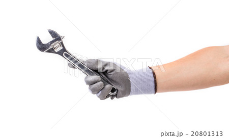 Hand in gloves holding adjustable wrench. Hand in gloves holding adjustable wrench. 20801313