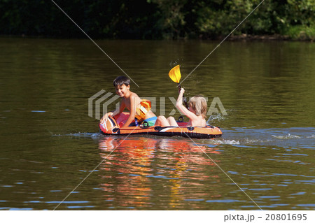 Two Boys Having Fun on Inflatable Rubber Boat Two Boys Having Fun on Inflatable Rubber Boat 20801695