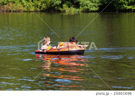 Two Boys Having Fun on Inflatable Rubber Boat Two Boys Having Fun on Inflatable Rubber Boat 20801696