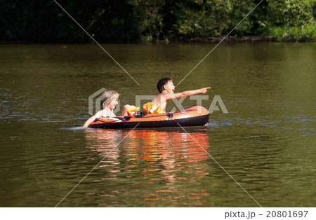 Two Boys Having Fun on Inflatable Rubber Boat 20801697