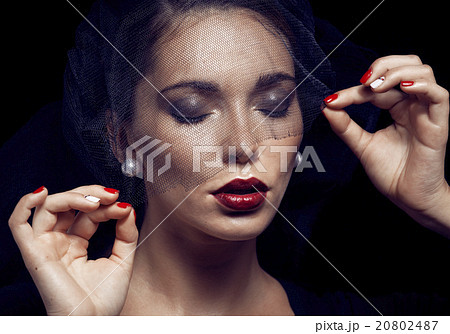 beauty brunette woman under black veil with red 20802487