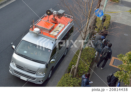 事件現場のテレビ取材陣と中継車の写真素材