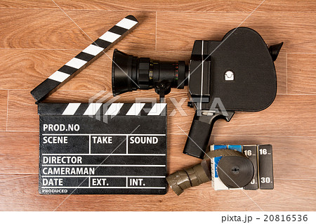 Old movie camera with a clapper and film. Old movie camera with a clapper and film. 20816536