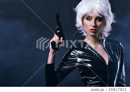 beautiful sexy girl holding gun . smoke background 20817821