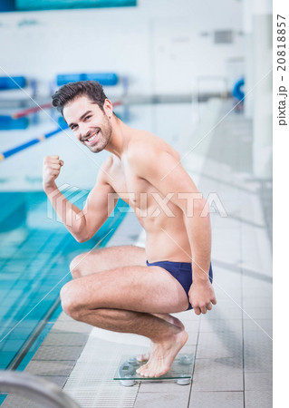 Fit man triumphing on the weighting scale Fit man triumphing on the weighting scale 20818857