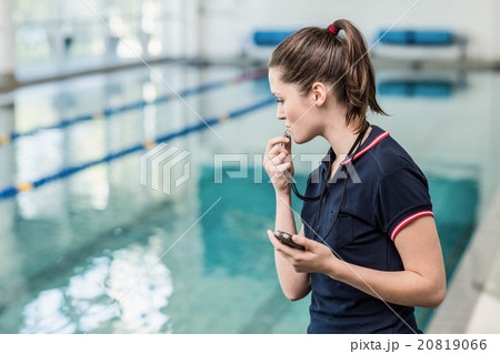 Fit woman blowing whistle 20819066