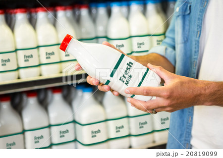 Man holding a bottle of milk 20819099