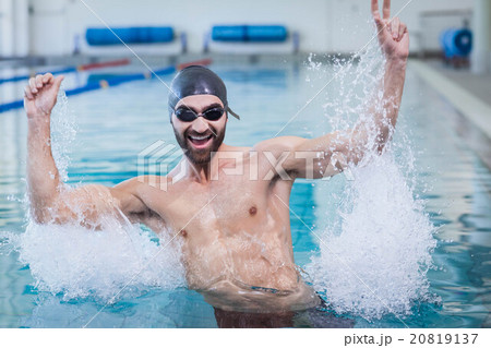 Smiling man triumphing with raised arms Smiling man triumphing with raised arms 20819137