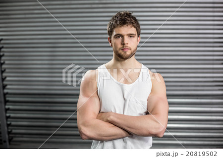 Front view of serious man crossing arms 20819502