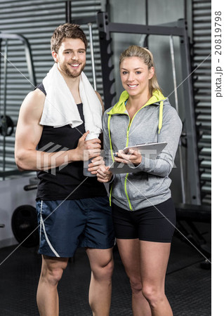 Smiling fit couple taking notes 20819798