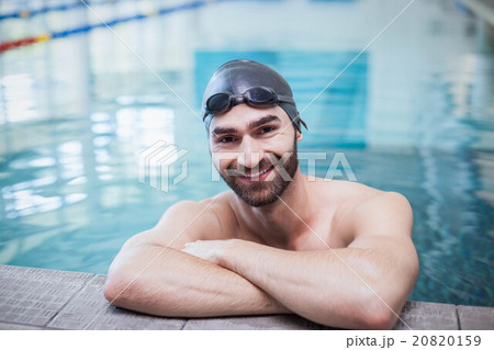Smiling man wearing swim cap and goggles 20820159