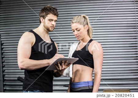 Smiling fit couple taking notes 20820451