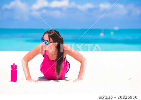 Fit young woman on tropical white beach in her Fit young woman on tropical white beach in her 20826950